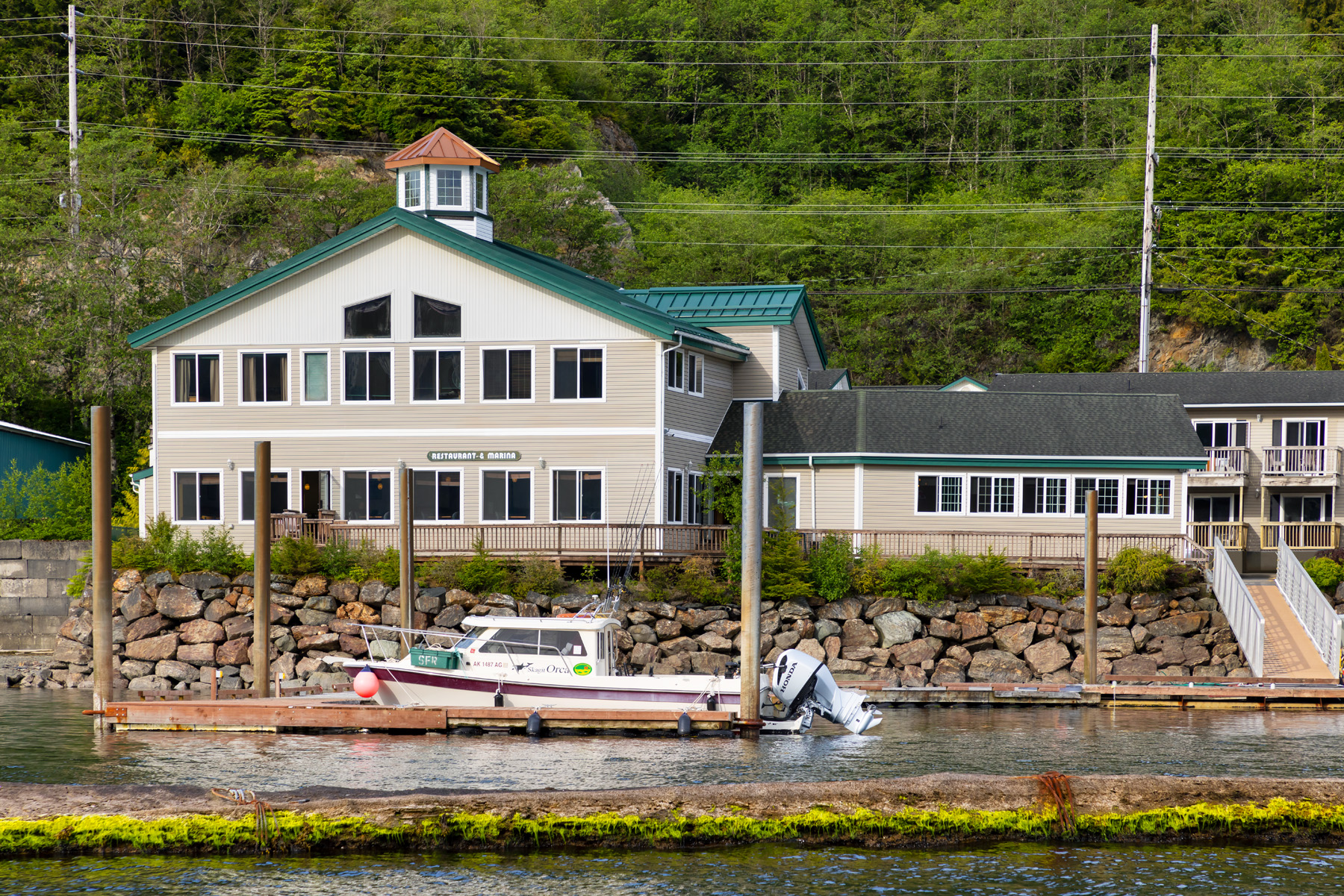 The Ketch Inn & Marina building with boat at dock